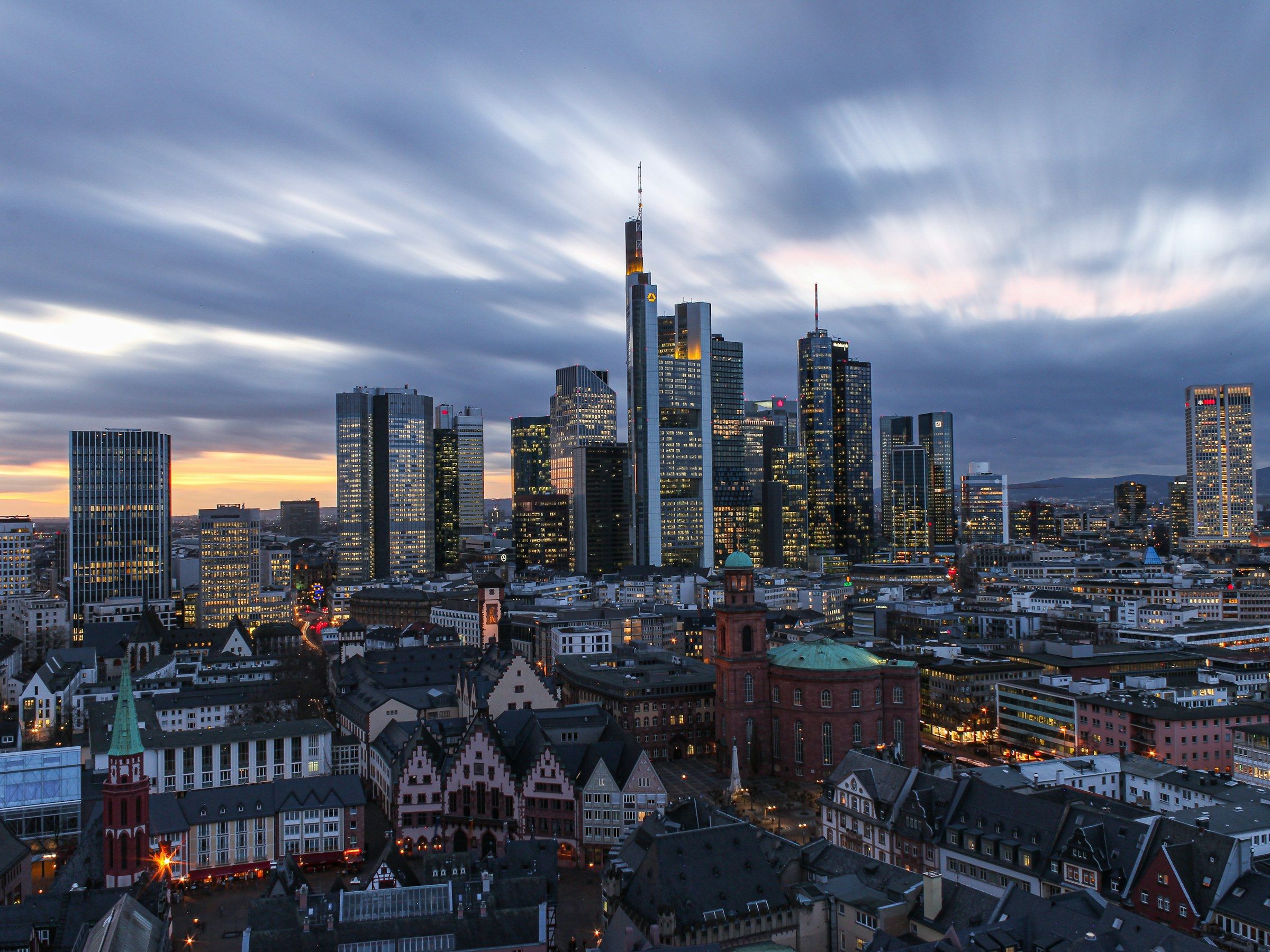 Frankfurt am Main skyline at blue hour, banking towers lit, with the Römer and Paulskirche in the foreground
